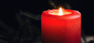 Photograph of an Yule candle and evergreen boughs, by Flickr user Ksenia Yakovleva and entered into the public domain.