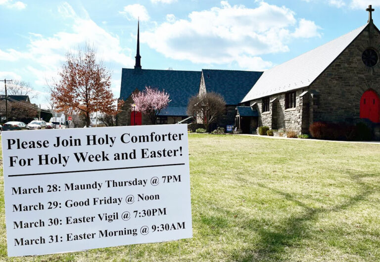 A sign outside Holy Comforter Church shows service times for Holy Week 2024